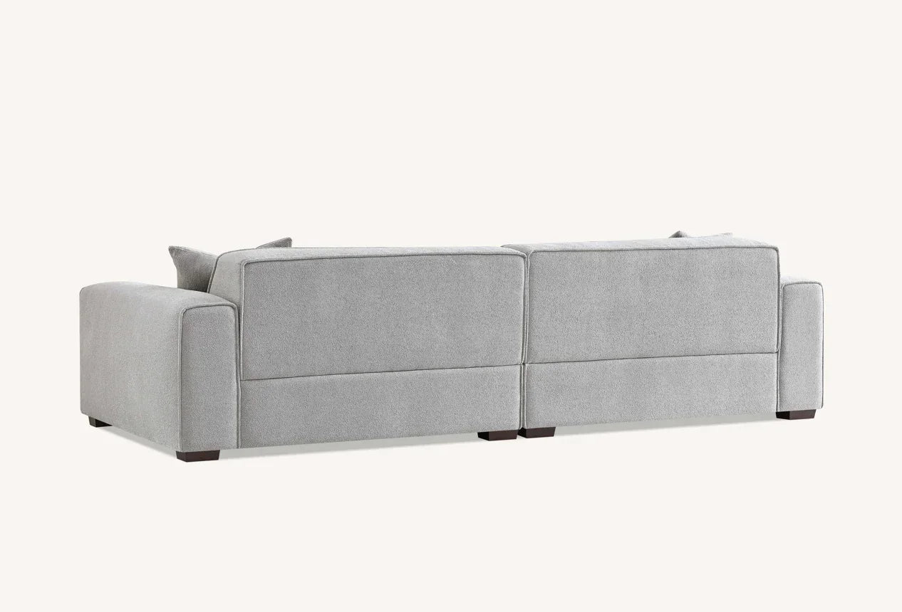 Rear view of modern light grey fabric sofa with low block legs and square arms