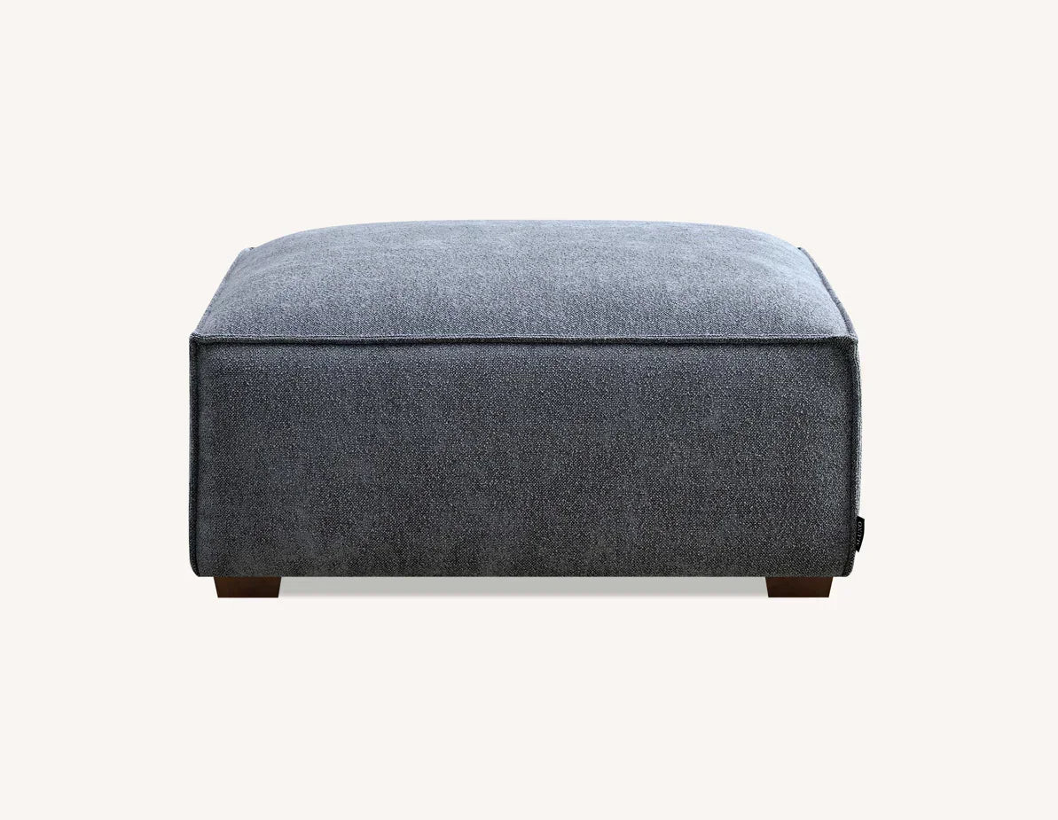 Grey fabric ottoman footstool with square design and low wooden feet, front view