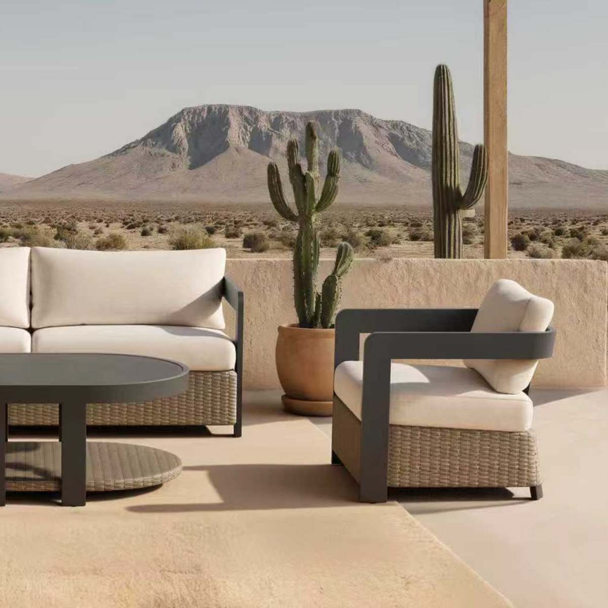 Beige cushioned outdoor rattan sofa and armchair with black metal arms on patio