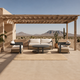 Beige cushioned rattan sofa set with dark metal frames under wooden pergola | Home Centre Direct UK