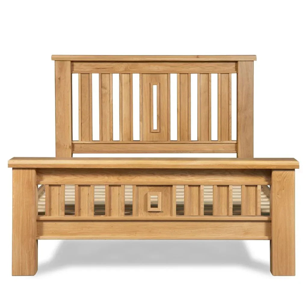 Oak bed frame with vertical slat headboard and footboard, front facing view