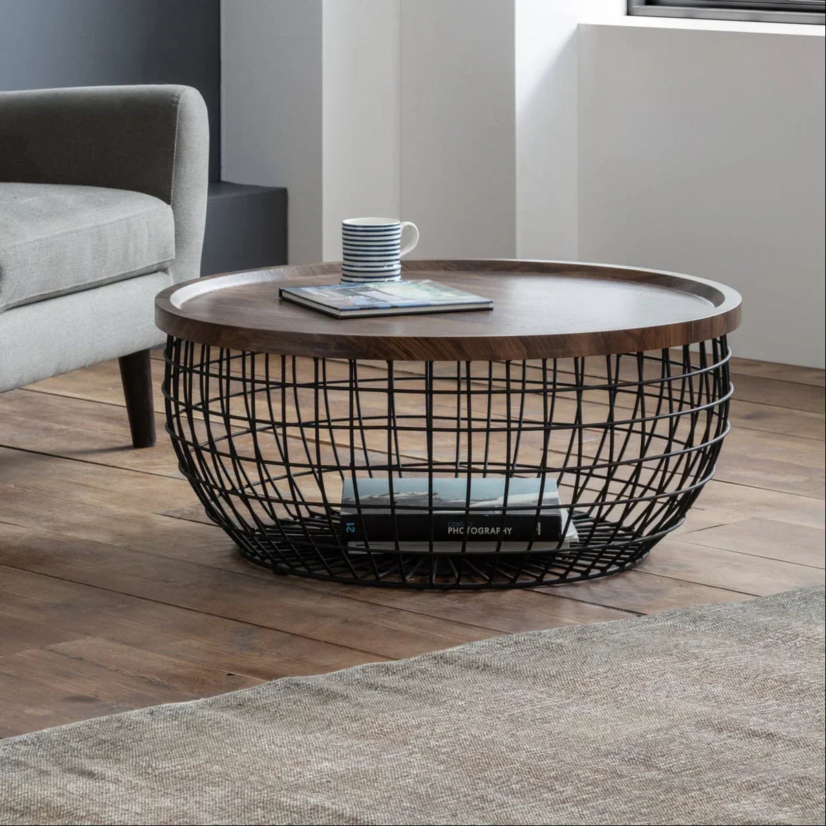 Smithson storage coffee table with black wire base and wooden top in modern living room