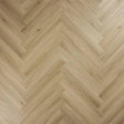 Light oak herringbone flooring with natural wood grain texture and chevron pattern