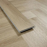 smokey oak laminate flooring plank on light wood herringbone floor close-up