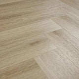 Light oak effect herringbone laminate flooring with wood grain texture
