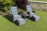 Grey rattan bistro garden set with two armchairs, ottomans and glass top table on lawn