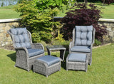 Grey rattan bistro garden set with two armchairs, footstools, and glass top table on lawn