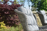 Grey rattan garden chair with padded cushion in outdoor patio setting