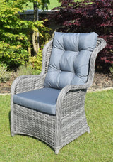 Grey rattan garden armchair with blue padded cushions on lawn