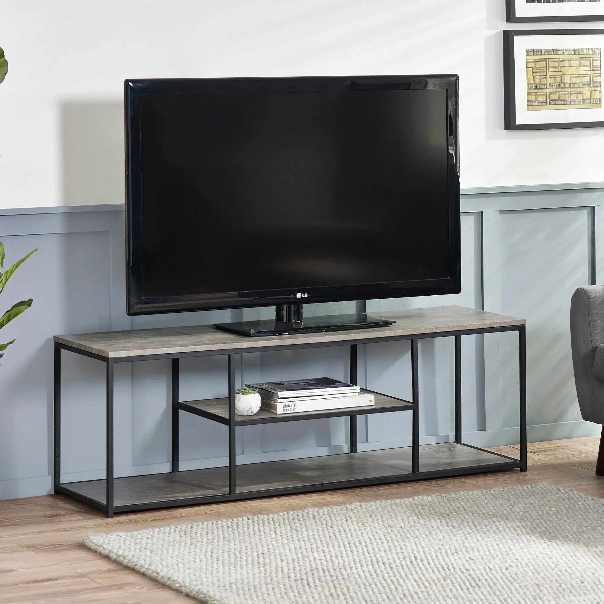 Modern TV unit with open shelves, metal frame, and wood finish in living room setting