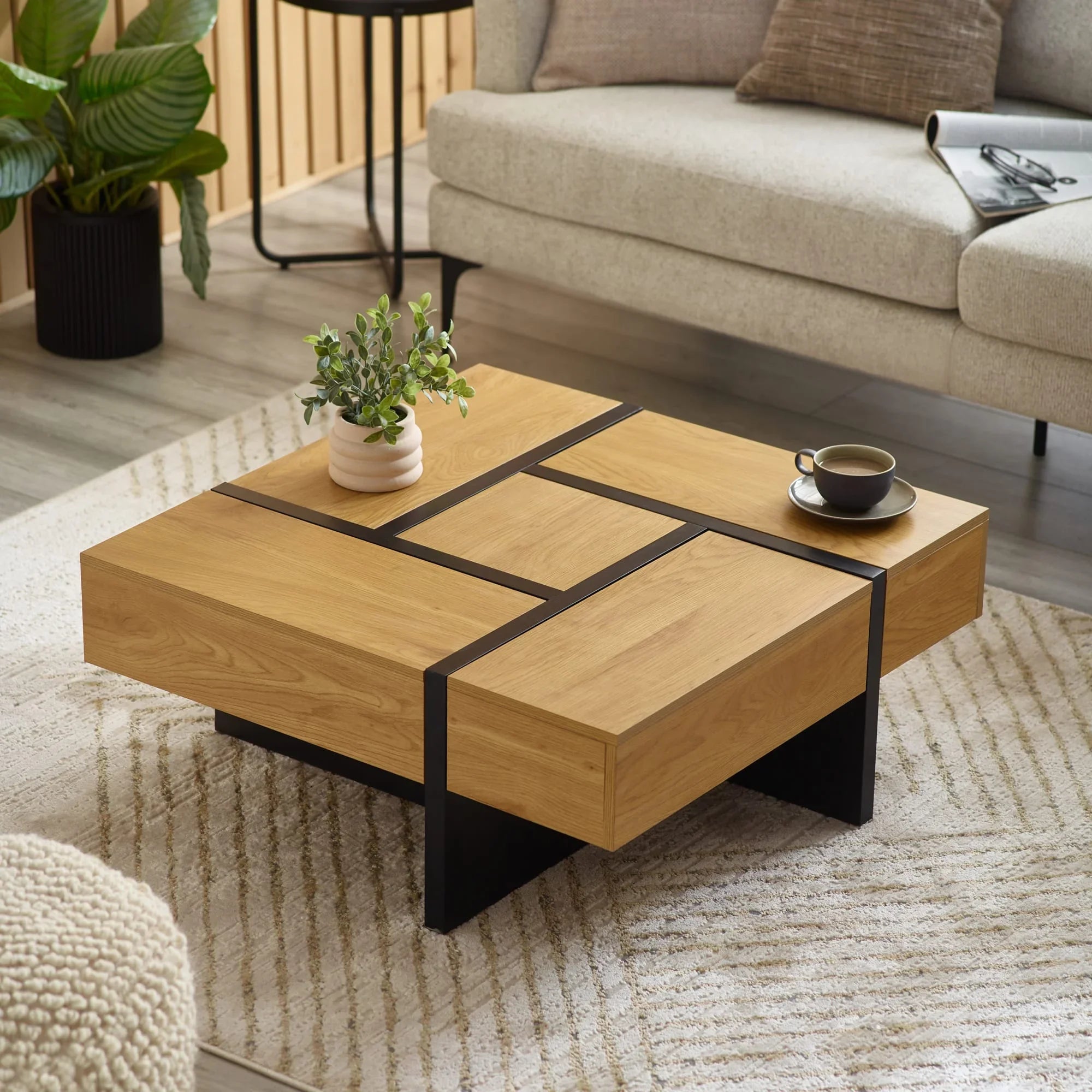 Modern oak coffee table with black metal accents in living room setting