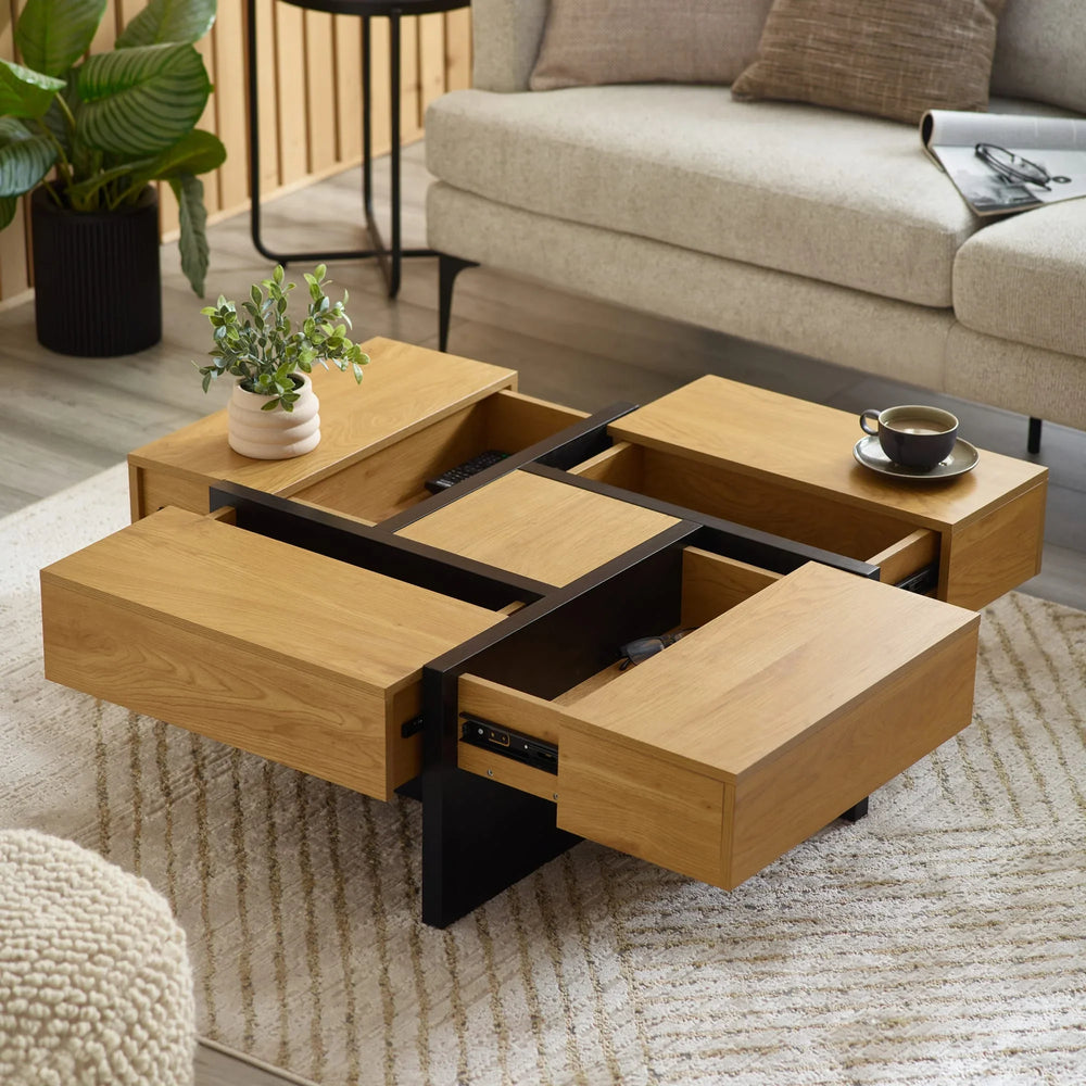 Oak coffee table with black frame, open storage drawers, cup and plant in modern living room