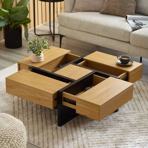 Oak coffee table with black frame, open storage drawers, cup and plant in modern living room