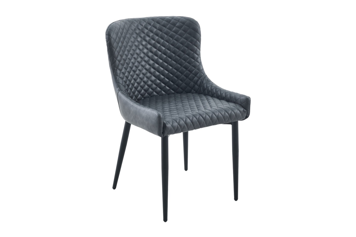 A modern dining chair upholstered in dark gray quilted faux leather with slim black metal legs, shown against a plain white background.