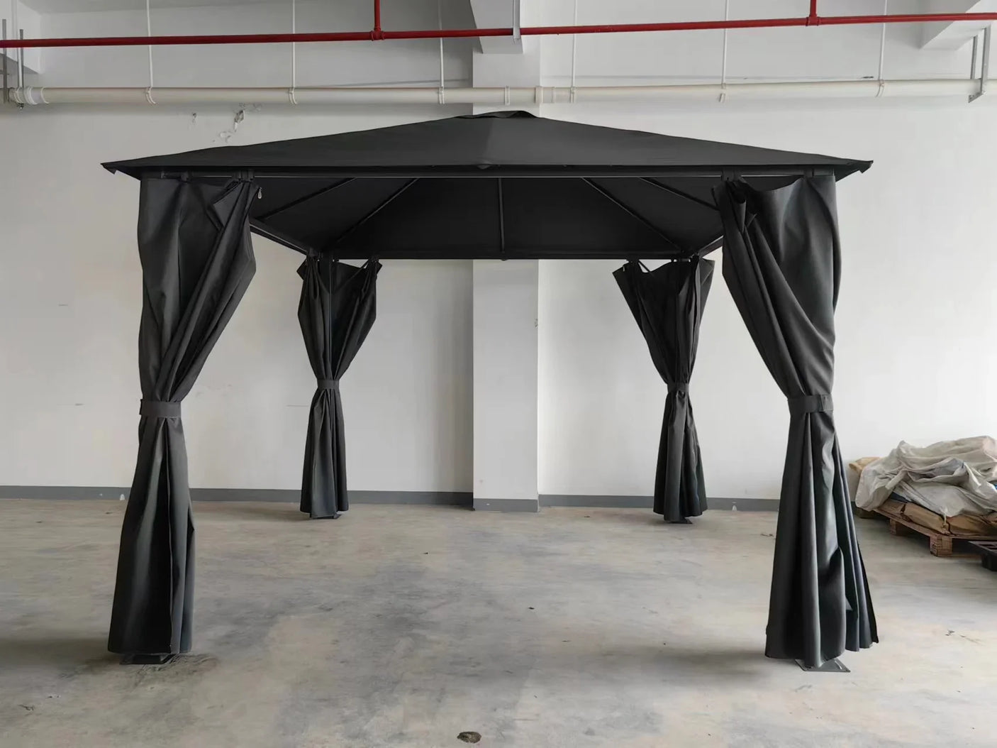 Black garden gazebo with four corner curtains and metal roof assembled indoors