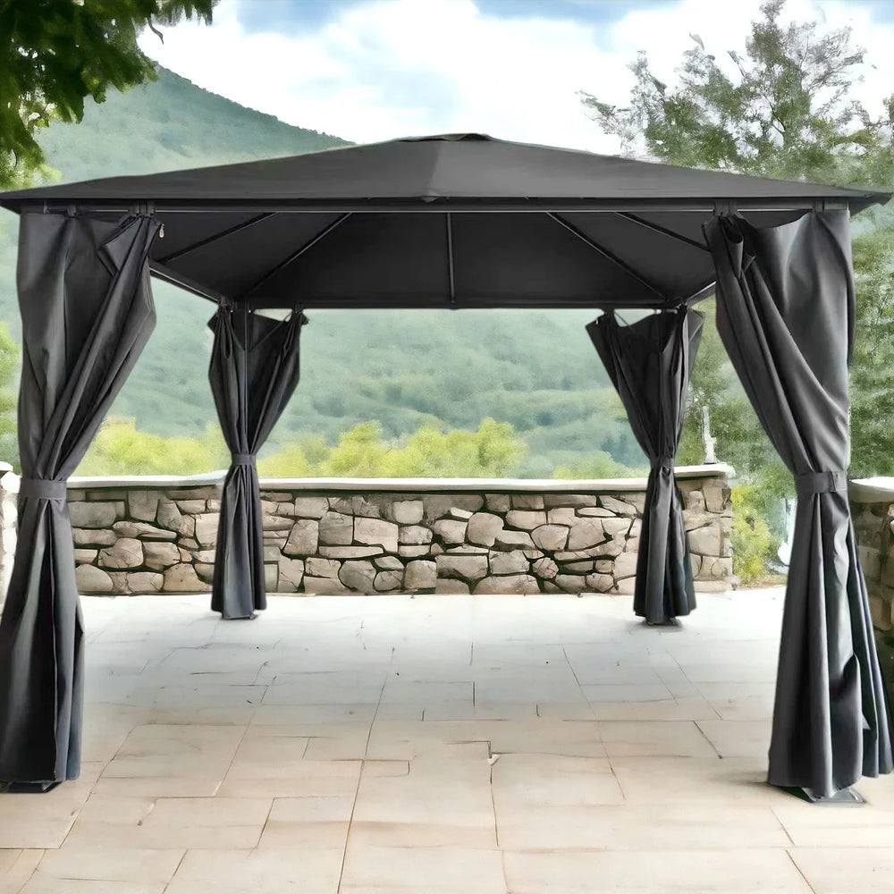 Grey outdoor gazebo with metal frame and curtains on stone patio with mountain view
