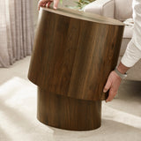 Hands lifting smaller dark wood oval table from beside larger table on light carpet near sofa