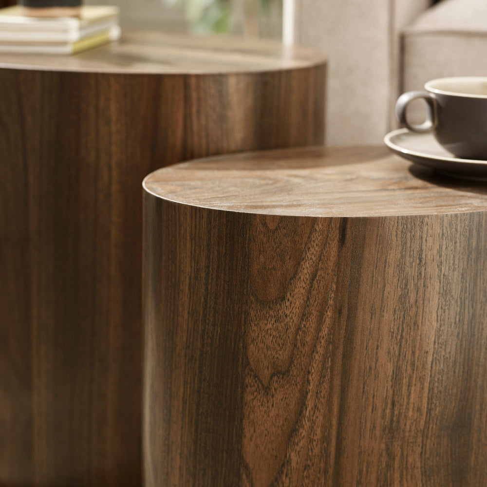 Close-up showing smooth curved edge and wood grain detail of dark wood oval nest tables