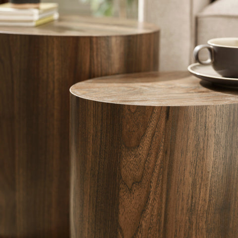 Close-up showing smooth curved edge and wood grain detail of dark wood oval nest tables