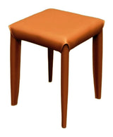 A square stool with a smooth, warm brown faux leather or leather upholstery and tapered legs, shown against a plain white background.