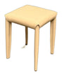 A modern square stool with a light beige upholstered seat and slim tapered legs, shown on a plain white background.