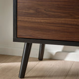 Close up view of black tapered legs on small TV unit with black wood finish