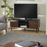 Large TV unit in black wood with walnut doors, holding a flat screen TV in a light living room setting.