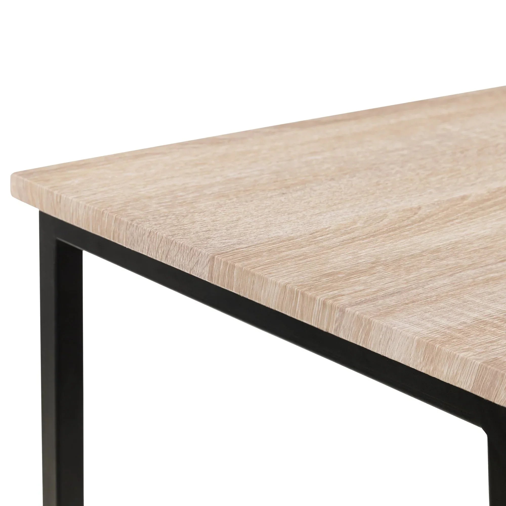 Sonoma oak desk corner with black metal frame, close-up of wood grain surface