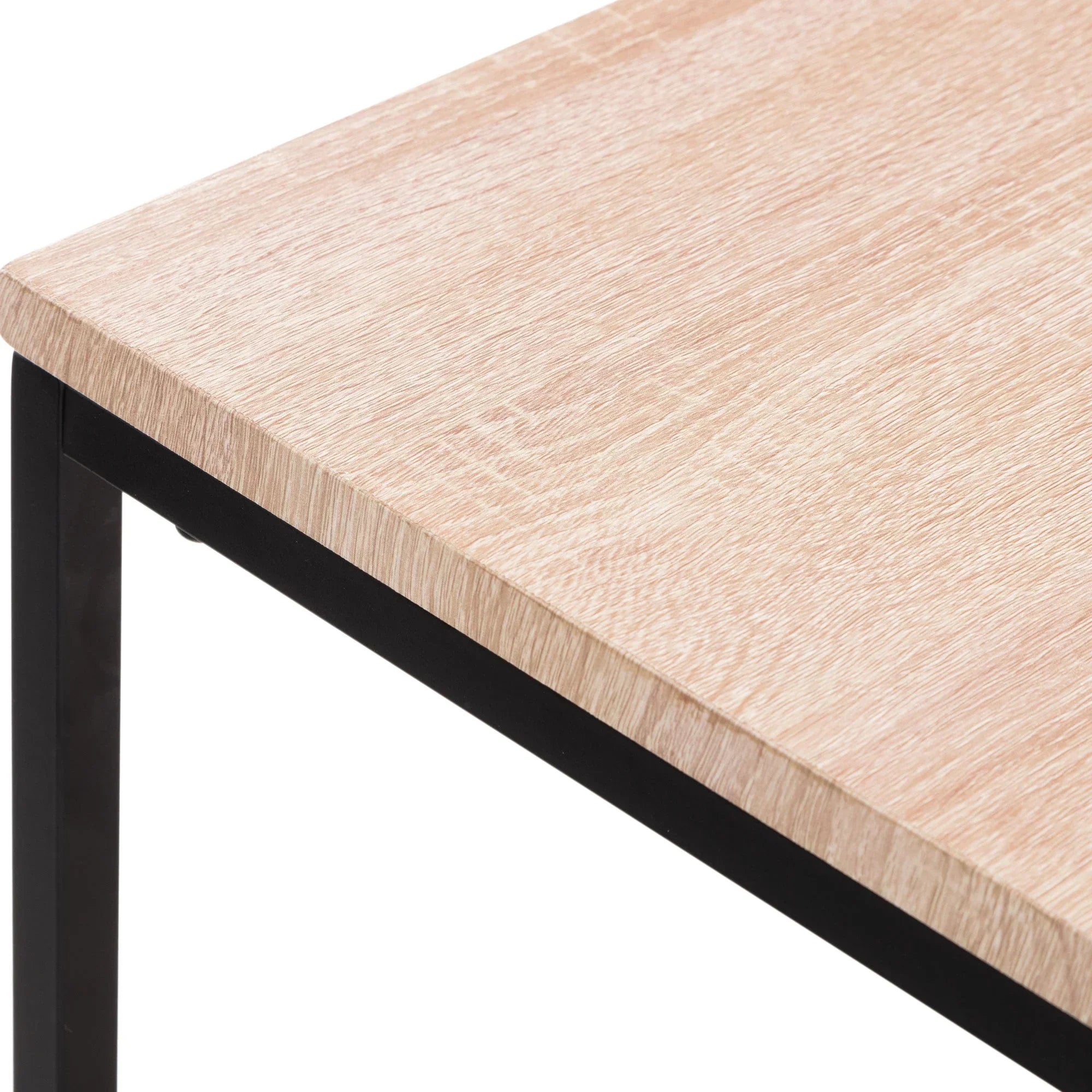Light oak dining table top with black metal frame, close-up of corner detail