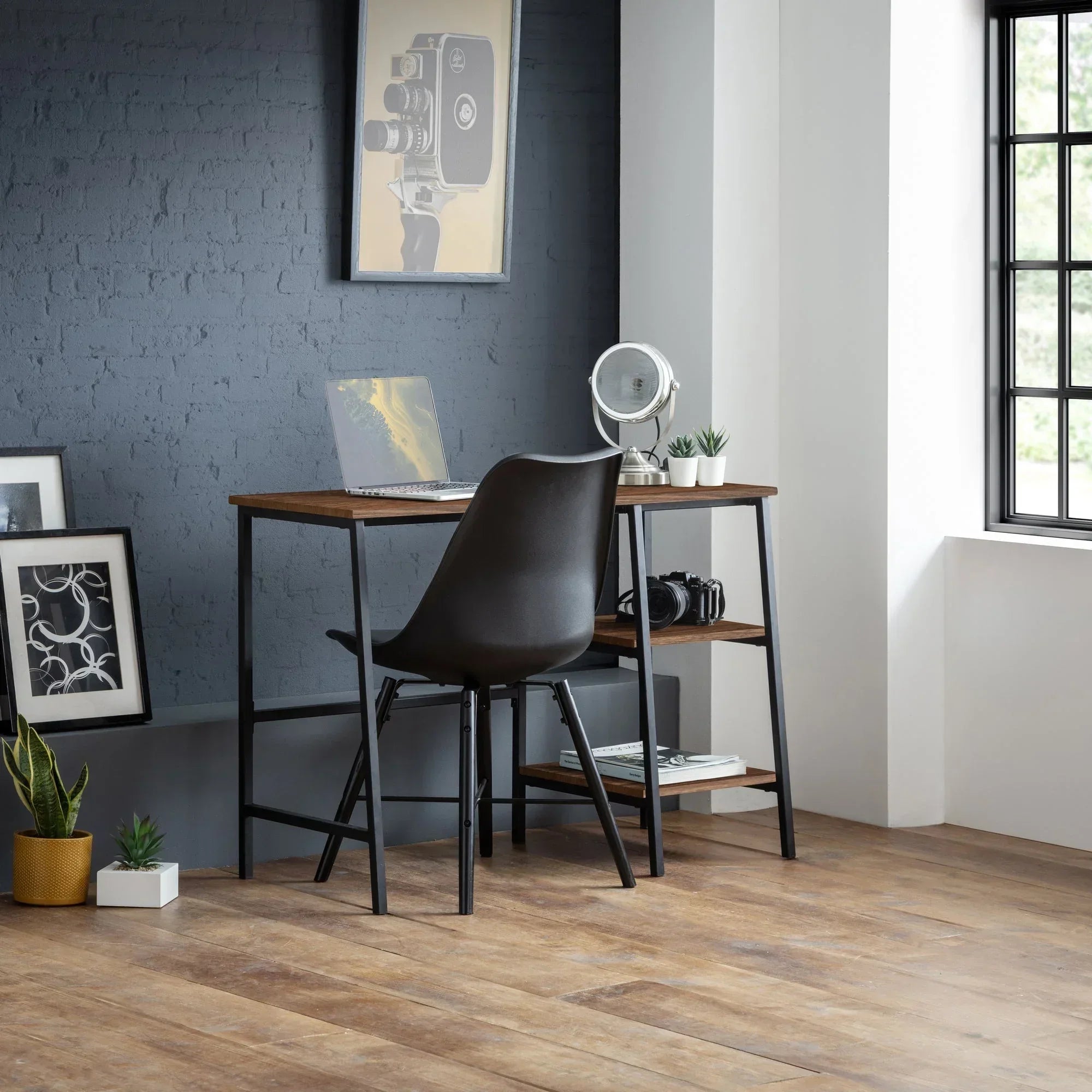 Walnut desk with black chair, shelving, and decor in a modern home office setting