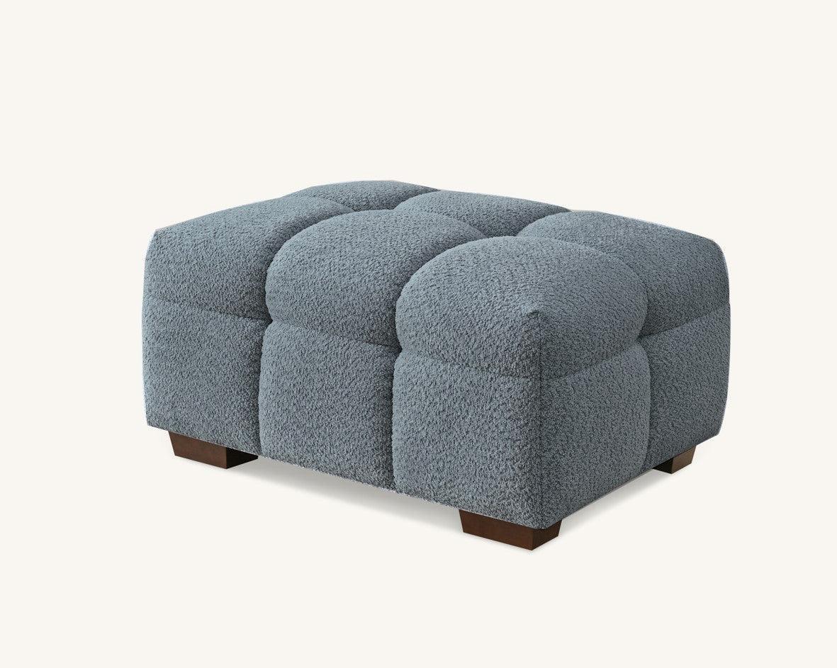 grey fabric upholstered stool with square tufted design and dark wooden legs