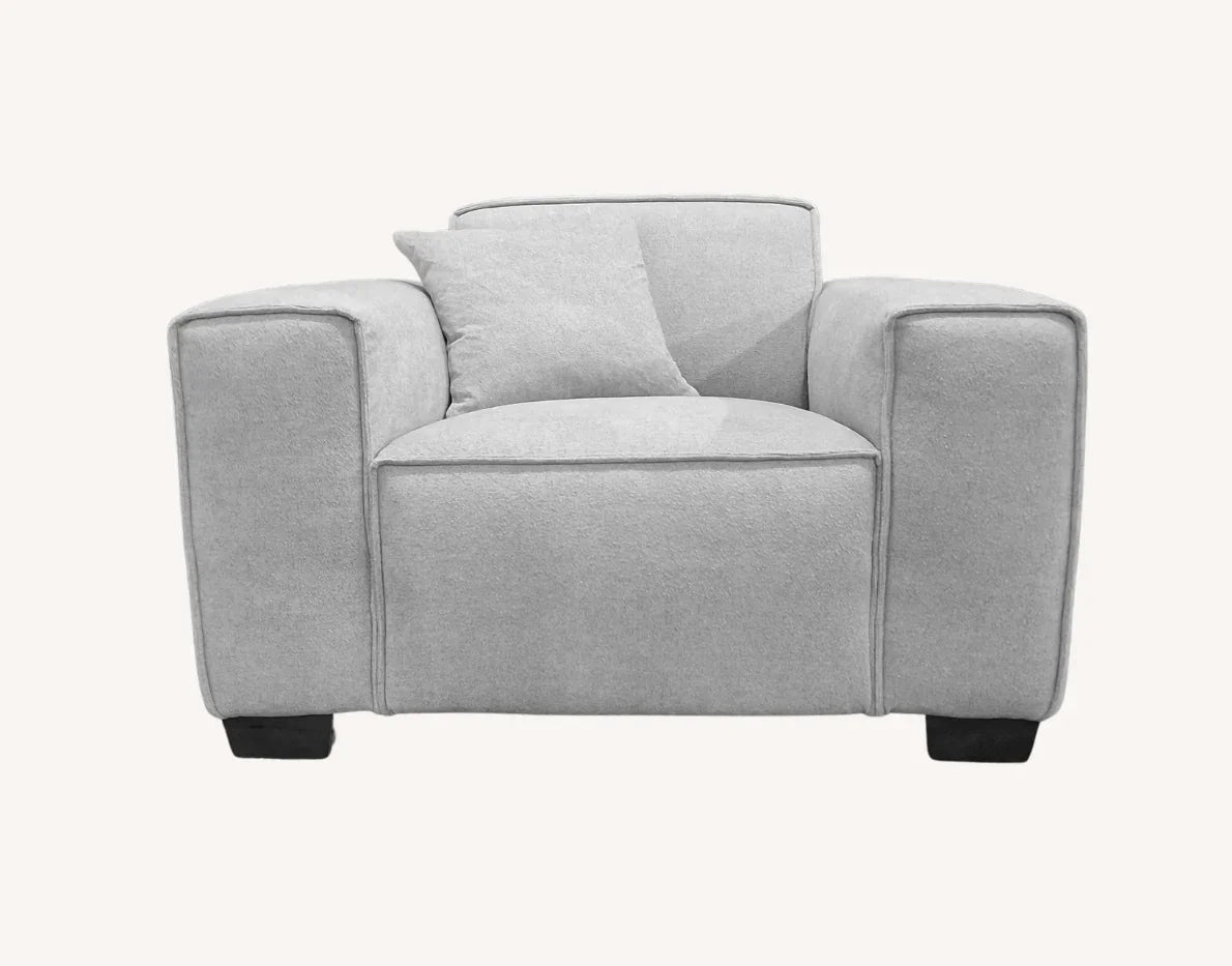 Light grey fabric armchair with wide arms and matching cushion, front view
