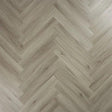 Urban grey wood flooring in herringbone pattern, close-up of textured laminate surface