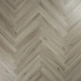 Urban grey wood flooring in herringbone pattern, close-up of textured laminate surface