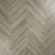 Urban grey wood effect flooring in herringbone pattern, close-up of textured surface