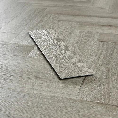Urban grey wood effect vinyl flooring plank on herringbone floor pattern