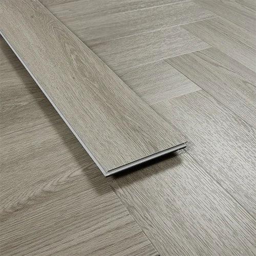 Urban grey wood effect vinyl flooring plank on herringbone patterned floor