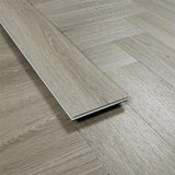 Urban grey wood effect vinyl flooring plank on herringbone patterned floor