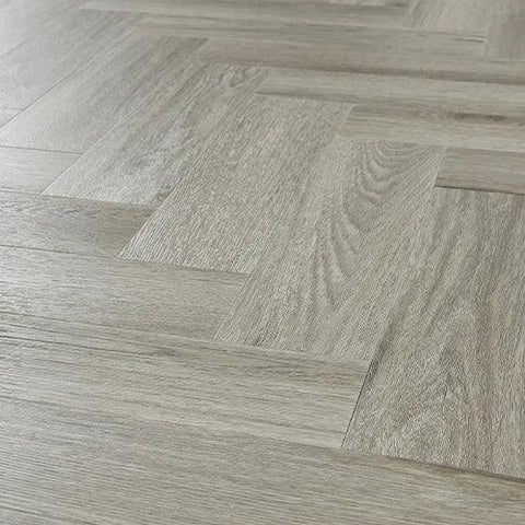 Urban grey laminate flooring in herringbone pattern with wood grain texture