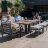 Modern outdoor garden furniture set with grey cushioned seating and rectangular dining table