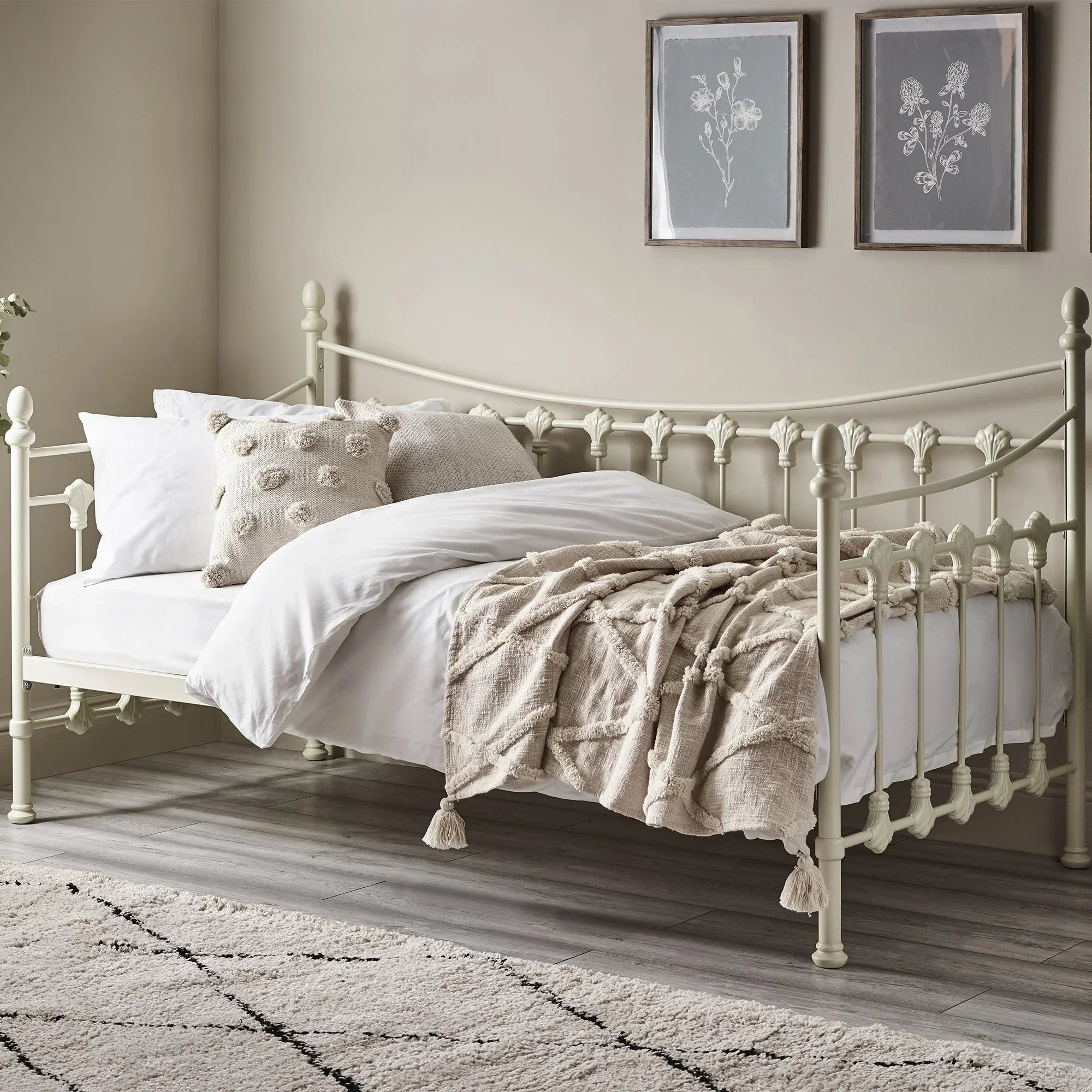 Stone white metal single daybed with bedding in modern bedroom setting