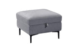 A square gray upholstered ottoman with black tapered legs and a small hanging pull handle on the front, shown on a plain white background.