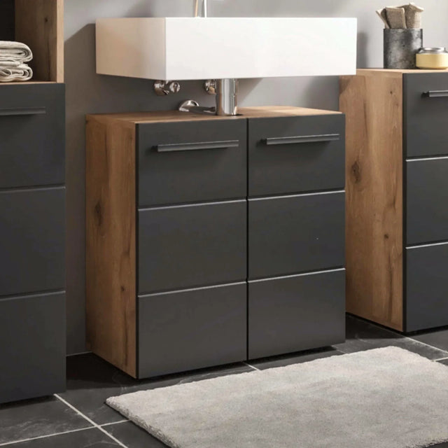 Modern bathroom vanity unit with black drawers and wood sides beneath white basin