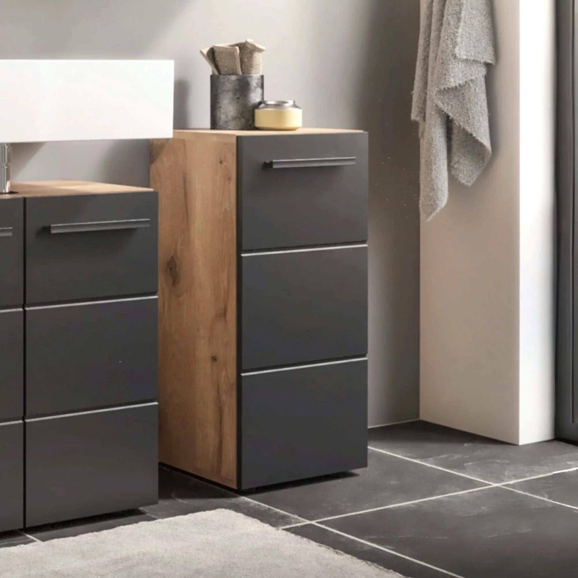 Modern bathroom storage cabinet with matte grey drawers and oak effect side panel