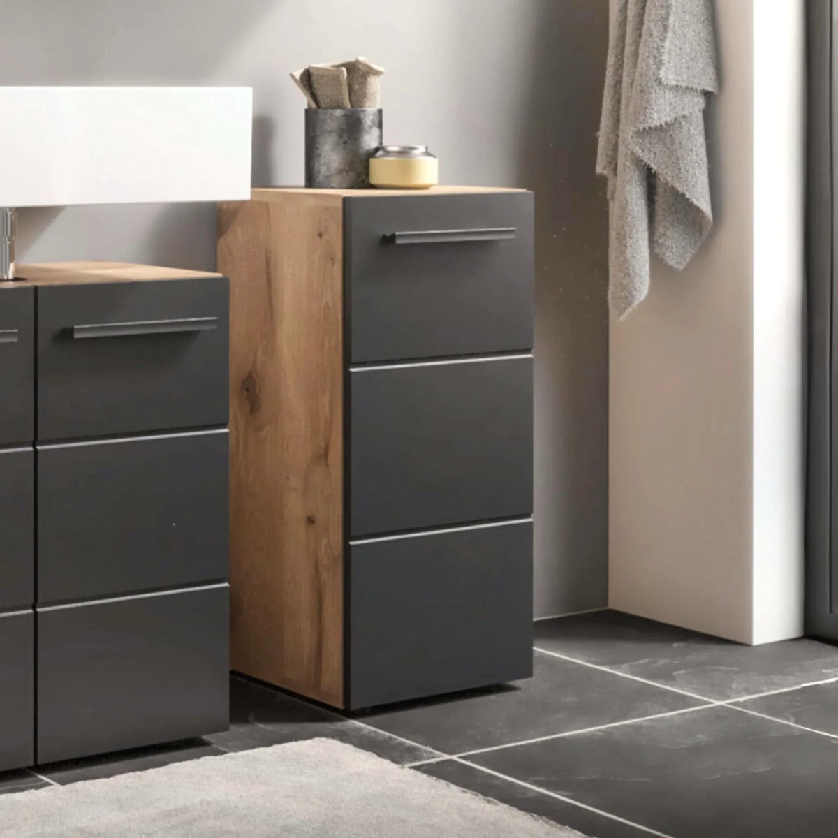 Modern bathroom storage cabinet with matte grey drawers and oak effect side panel