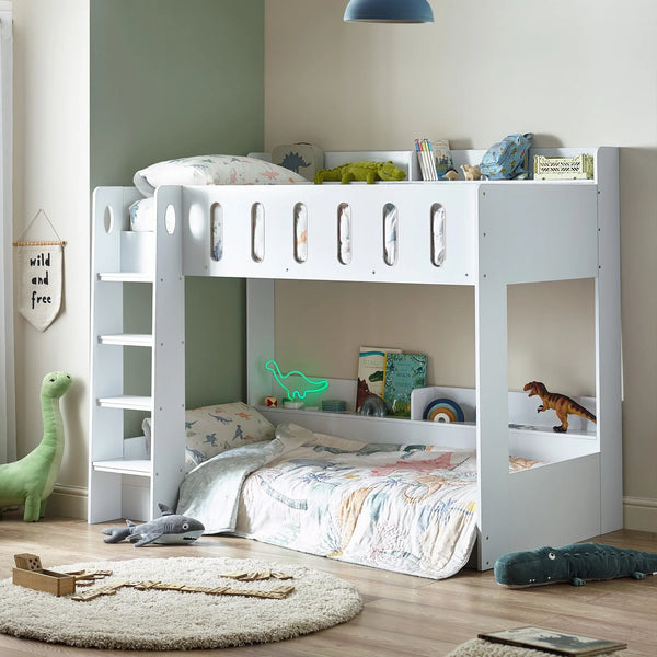 White wooden bunk bed in kids’ room with dinosaur bedding and ladder
