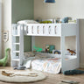 White wooden bunk bed in kids’ room with dinosaur bedding and ladder