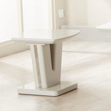 Glossy cream lamp table with V-shaped base on light wood floor