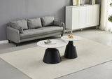 Round coffee table and lamp table set with black bases and white tops in modern living room