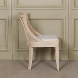 Light Wooden Sloped Rattan Upholstered Dining Chair with birch wood and linen in a natural finish
